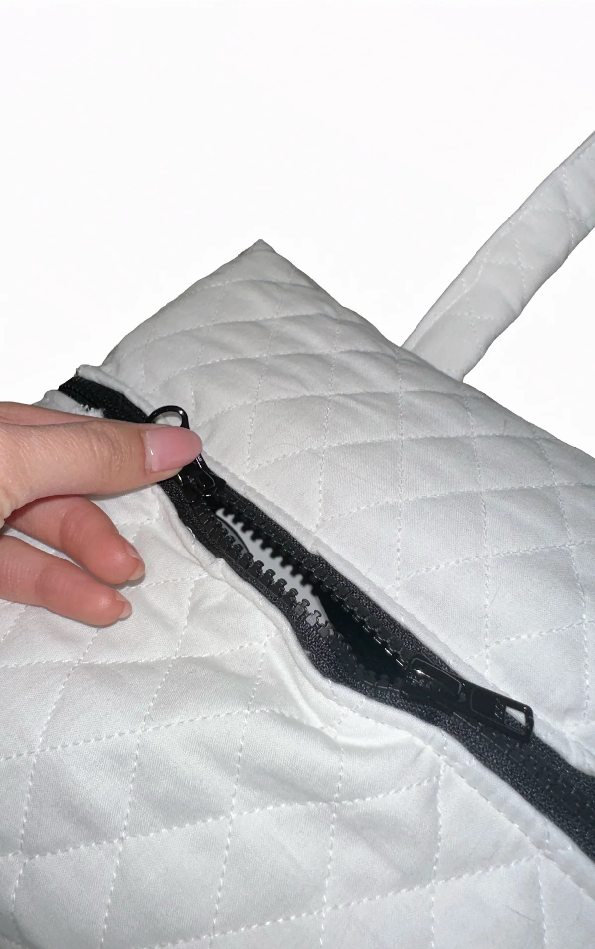 Close up of the black zipper on quilted fabric