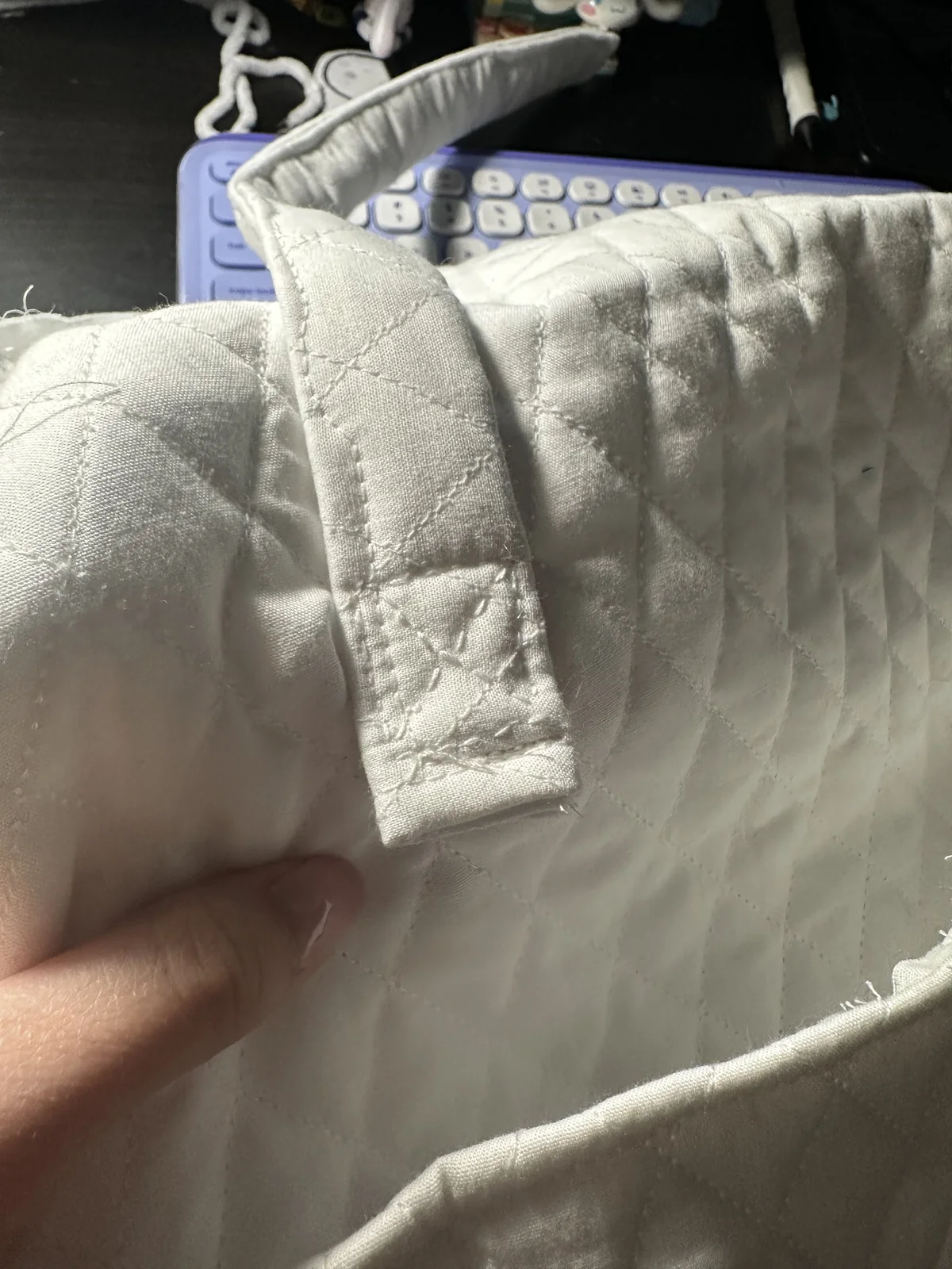 Quilted bag handle being folded