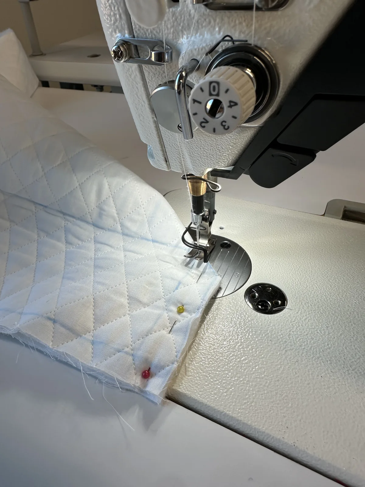 Sewing machine stitching quilted fabric